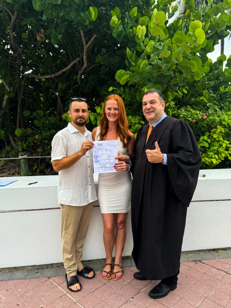 Couple holding their marriage certificate